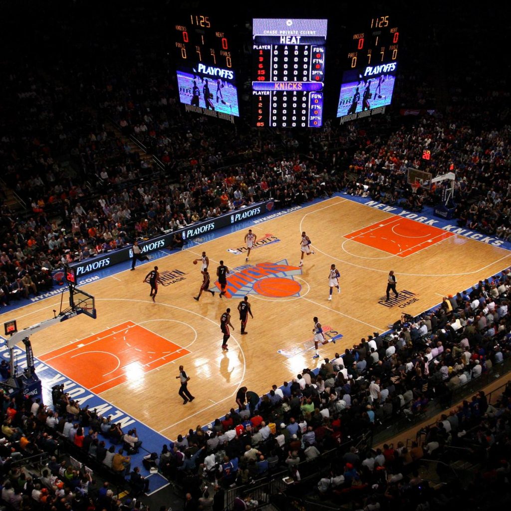 Image shows a basketball game being played inside of Madison Square Garden. 